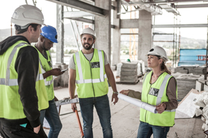 construction team collaborating on plans at site five workers discussing safety and efficiency in building process 6 important aspects