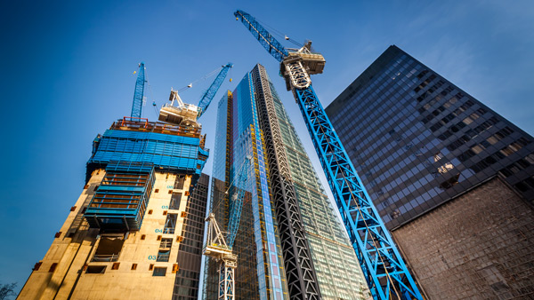 construction site with tall cranes and modern buildings construction progress blue cranes and skyscrapers